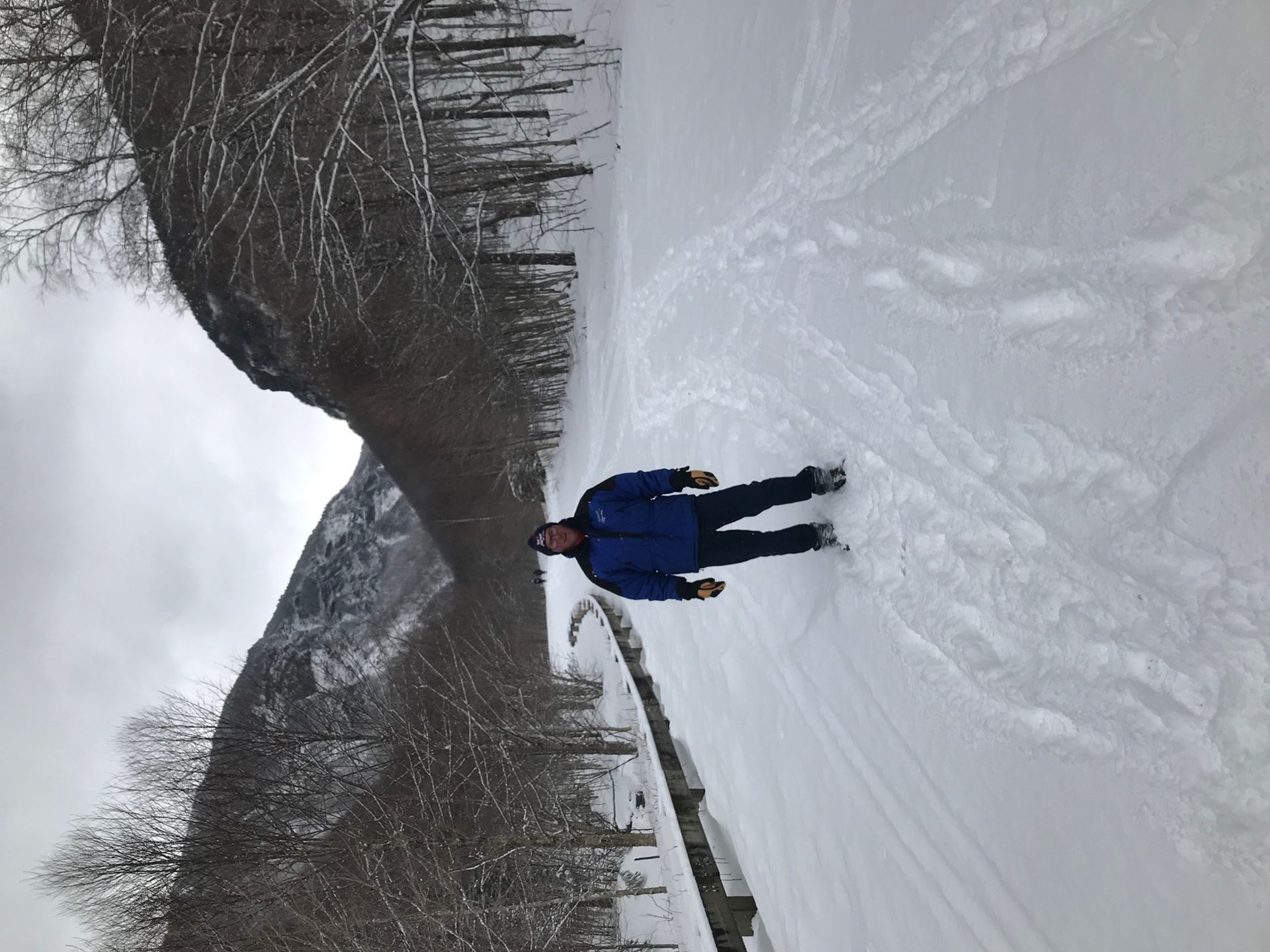 man snowshoeing a trail